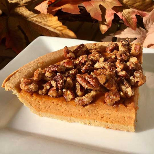 Sweet potato pie in a piccola cucina gluten free almond crust topped with pecan praline