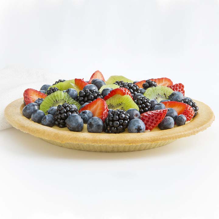 Golden sweetened almond crust pie shell crust from Piccola Cucina filled with custard and topped with kiwi, blueberries, strawberries, blackberries