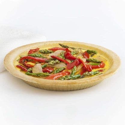 Golden unsweetened pie shell crust filled with asparagus, red bell pepper, onions with egg mixture waiting to be baked into quiche by Piccola Cucina